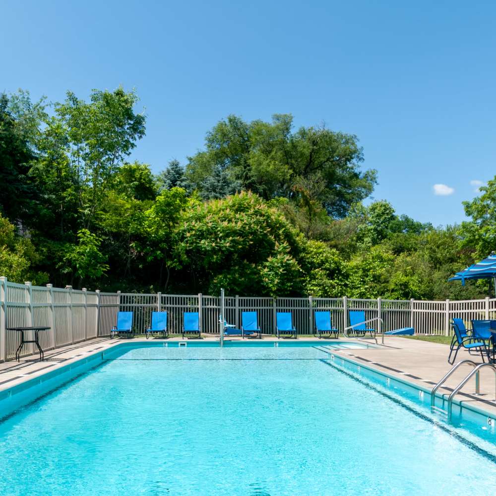 Swimming pool surrounded by lounge chairs at Nineteen North Apartments in Pittsburgh, Pennsylvania