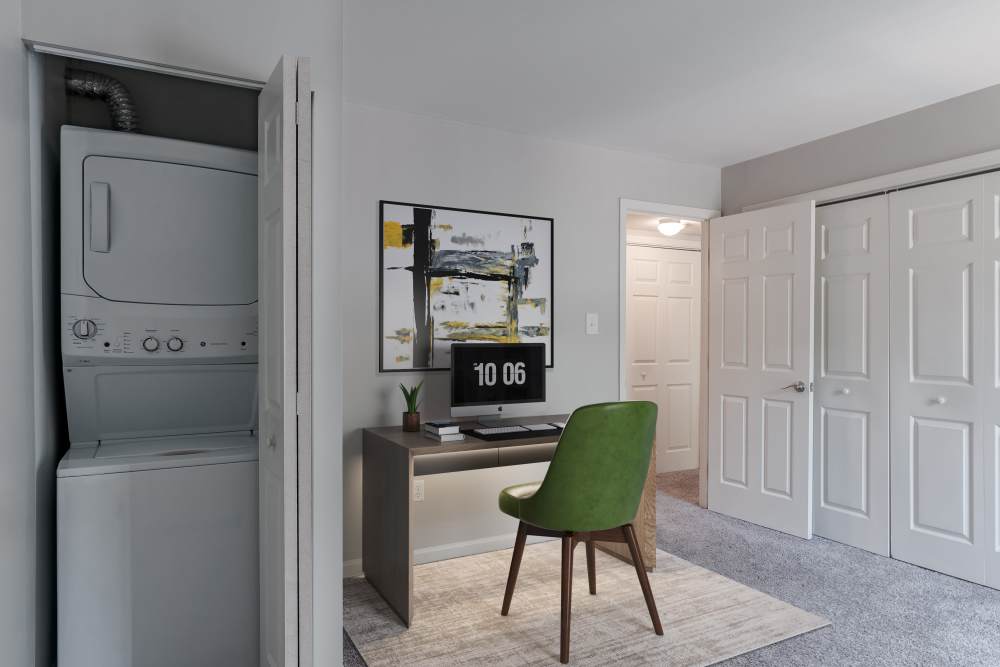 Bedroom staged as a home office with in-unit laundry at Nineteen North Apartments in Pittsburgh, Pennsylvania