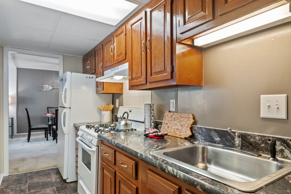 Kitchen with Wooden Cabinetry at Oxford Manor Apartments & Townhomes in Mechanicsburg, Pennsylvania