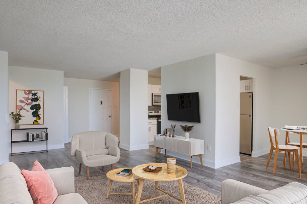 Modern living room with wall-mounted TV at Place One Apartment Homes in Plymouth Meeting, Pennsylvania