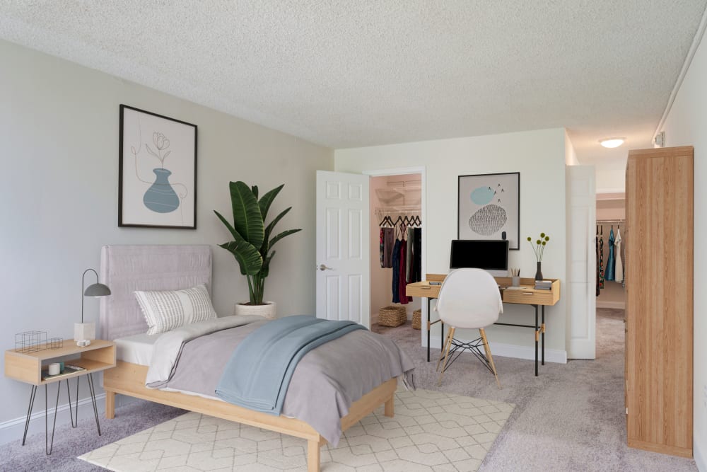 Minimalist Bedroom with Mini Office Table and Plush Carpeting at Place One Apartment Homes in Plymouth Meeting, Pennsylvania