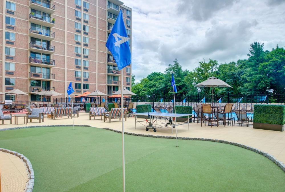 Outdoor lounge area with mini gold course at Place One Apartment Homes in Plymouth Meeting, Pennsylvania