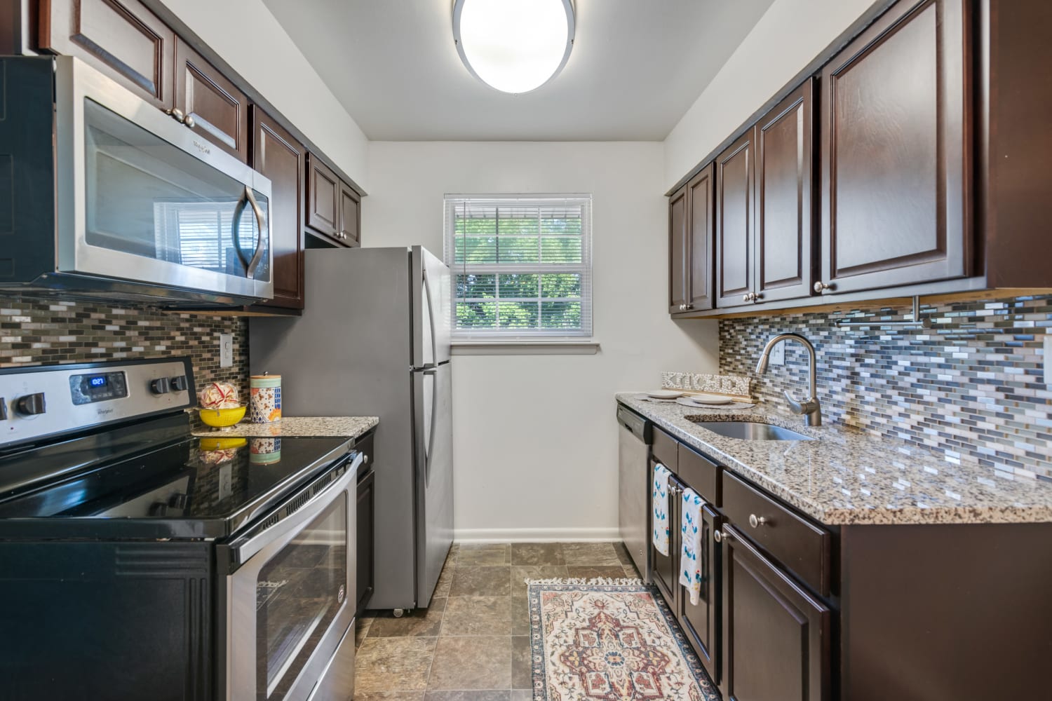 Modern galley-style kitchen at Roberts Mill Apartments & Townhomes in Maple Shade, New Jersey