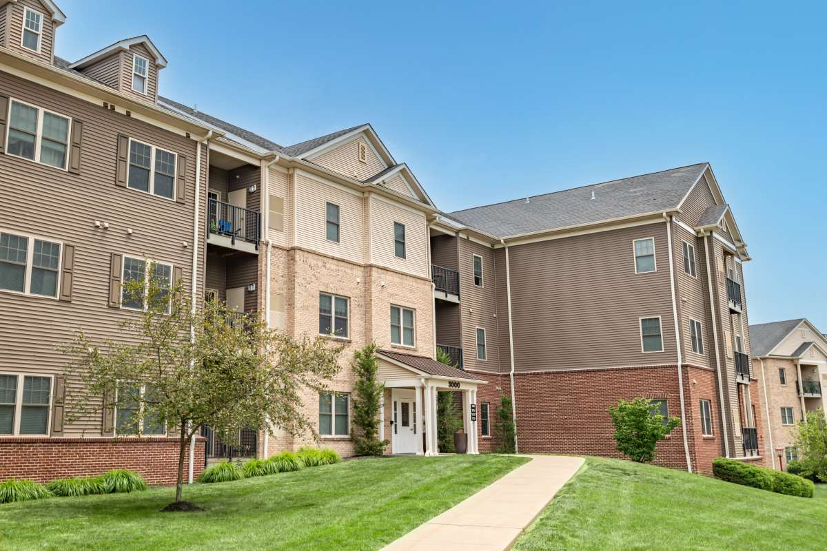 Exterior of apartment buildings with lots of green space and private balconies