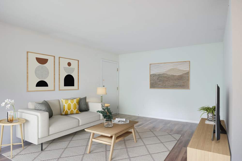 Cozy living area with wall-to-wall carpeting at Squires Manor Apartment Homes in South Park, Pennsylvania