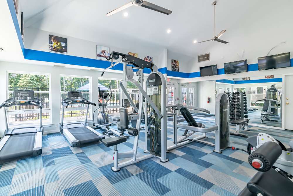 Fitness studio with treadmills and weight machines at The Landings Apartment Homes in Absecon, New Jersey