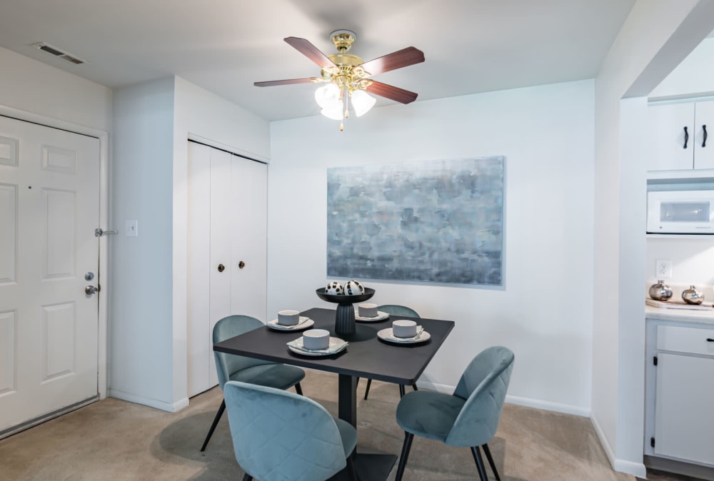 Dining area with ceiling fan at The Landings Apartment Homes in Absecon, New Jersey