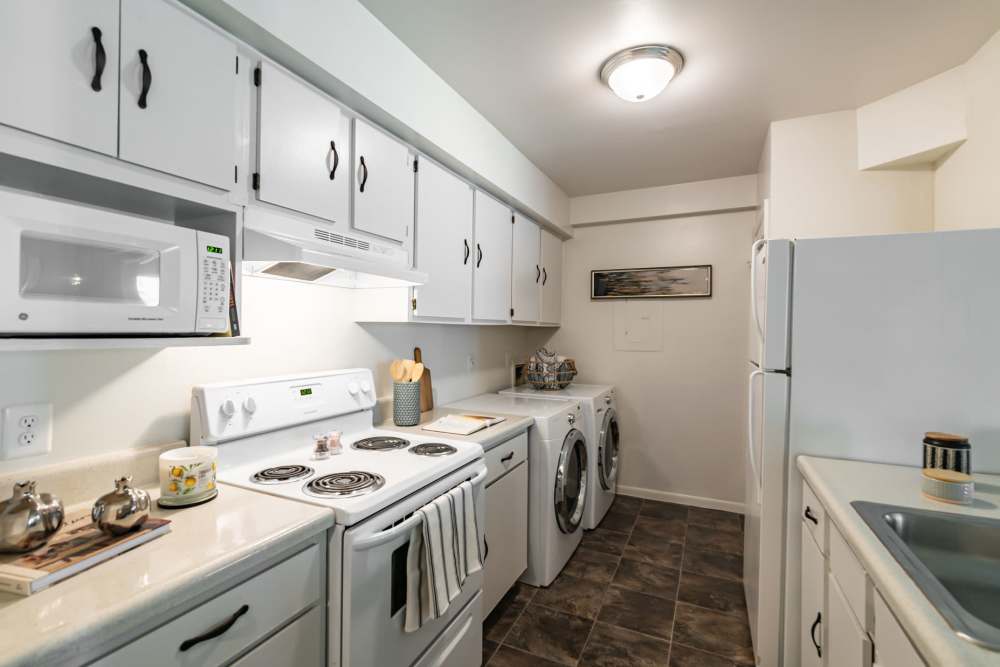 Fully equipped kitchen with white wood cabinets at The Landings Apartment Homes in Absecon, New Jersey