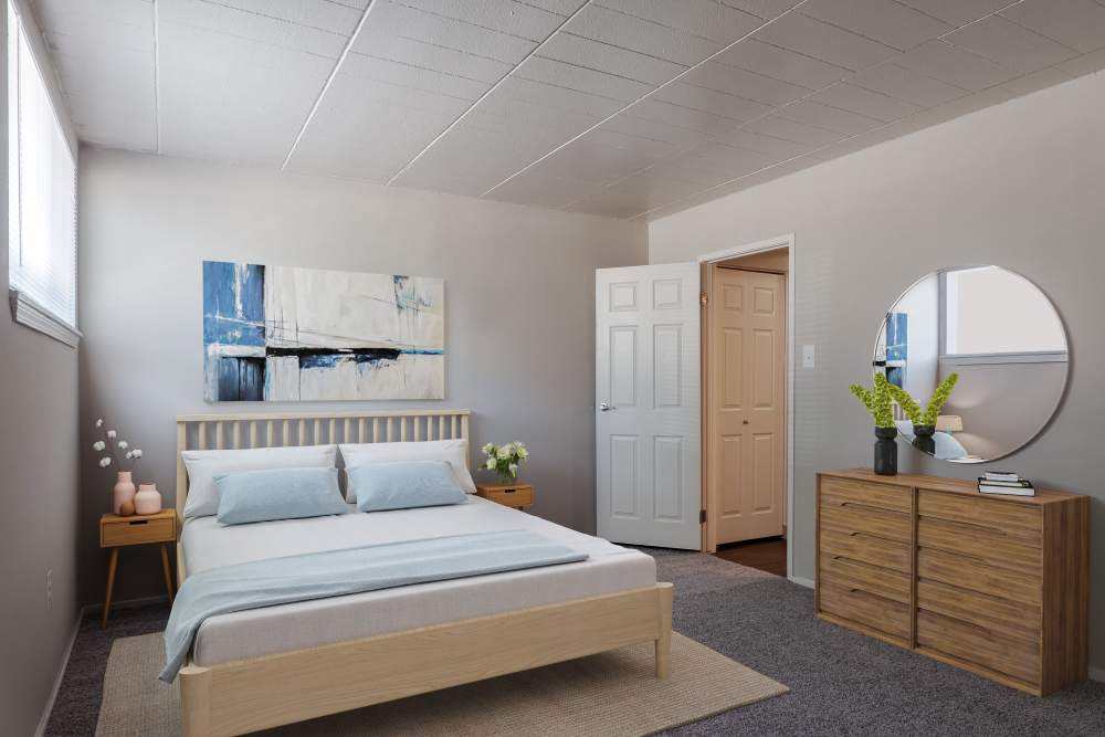 Staged bedroom with carpeting throughout at The Cascades Townhomes and Apartments in Pittsburgh, Pennsylvania