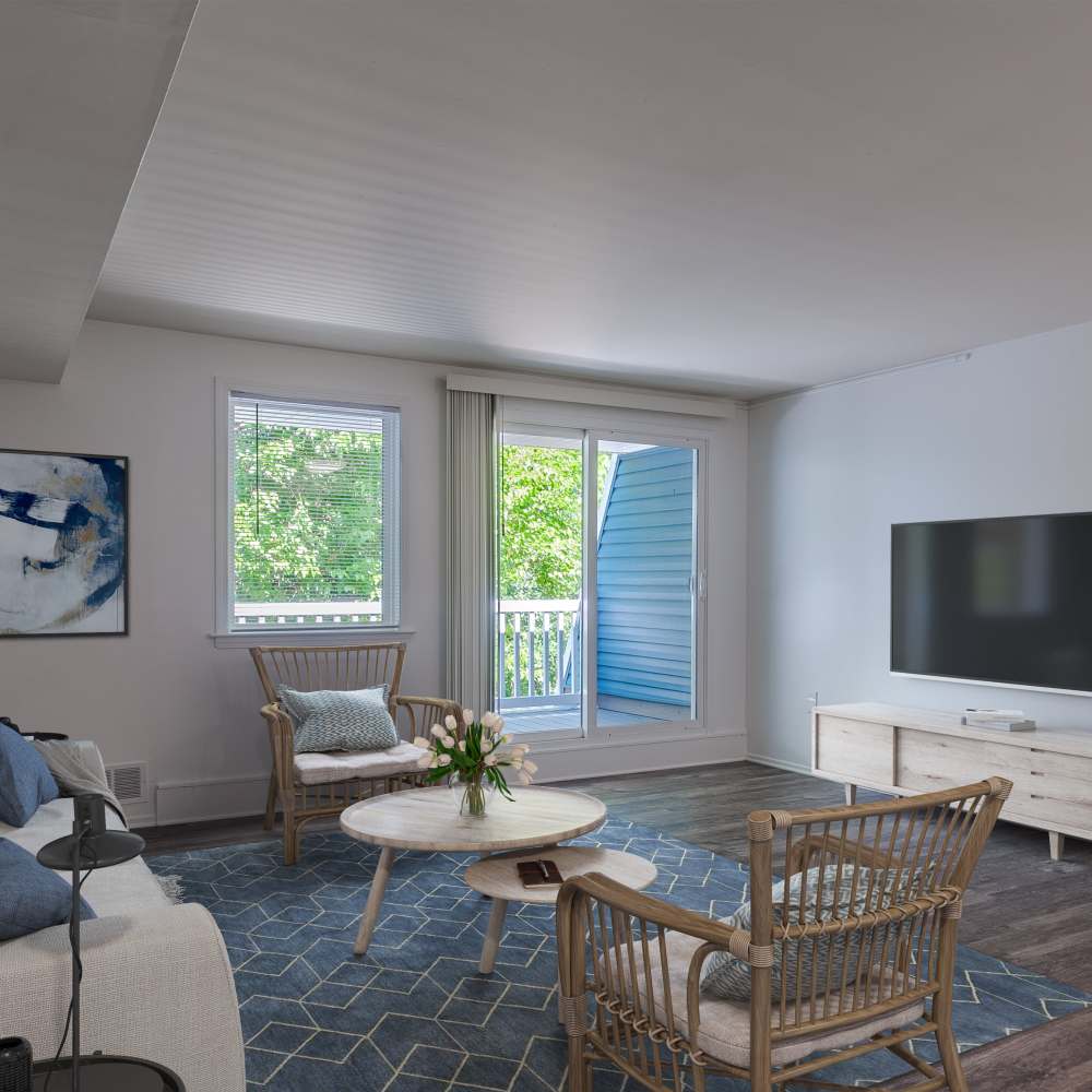 Model living room with hardwood-style flooring at The Cascades Townhomes and Apartments in Pittsburgh, Pennsylvania