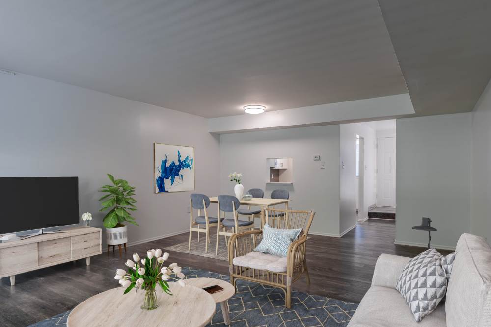 Spacious living room and dining area of a model home at The Cascades Townhomes and Apartments in Pittsburgh, Pennsylvania