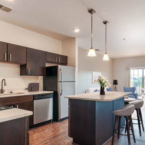 Open concept model living room with faux wood flooring at The Kane in Aliquippa, Pennsylvania