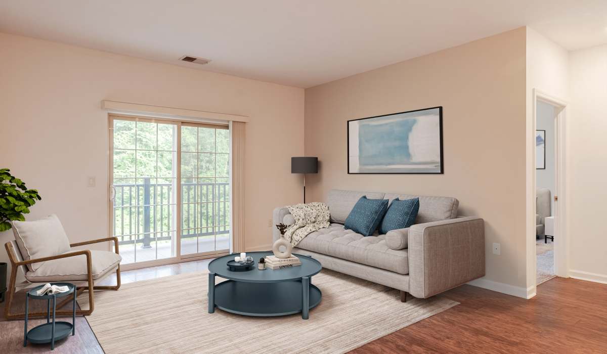 Spacious living room with couch, coffee table and access to patio through door at The Kane, Aliquippa, Pennsylvania