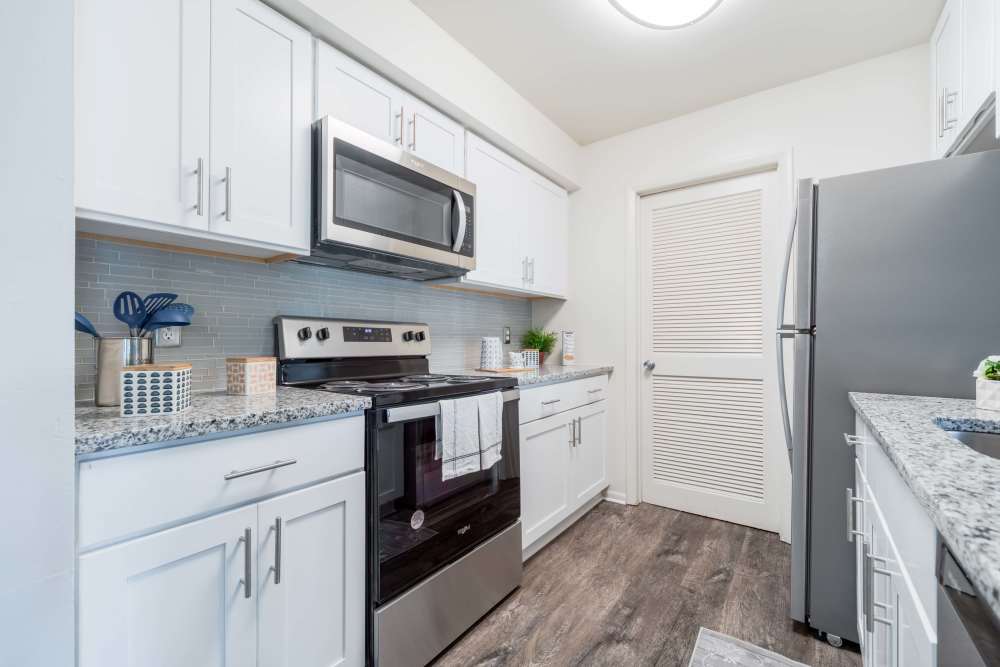 Kitchen with white cabinets and stainless-steel appliances at The Landings Apartment Homes in Absecon, New Jersey