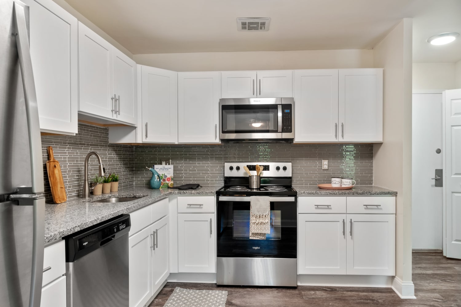 Kitchen area with white cabinetry at Timberlake Apartment Homes in East Norriton, Pennsylvania