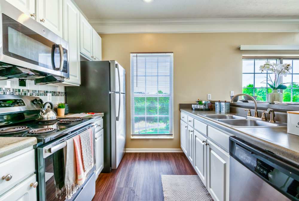 Tiled kitchen with white cabinets at The Waterfront Apartments & Townhomes in Munhall, Pennsylvania