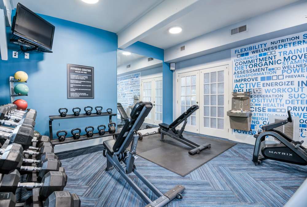 Fully equipped fitness center at The Waterfront Apartments & Townhomes in Munhall, Pennsylvania