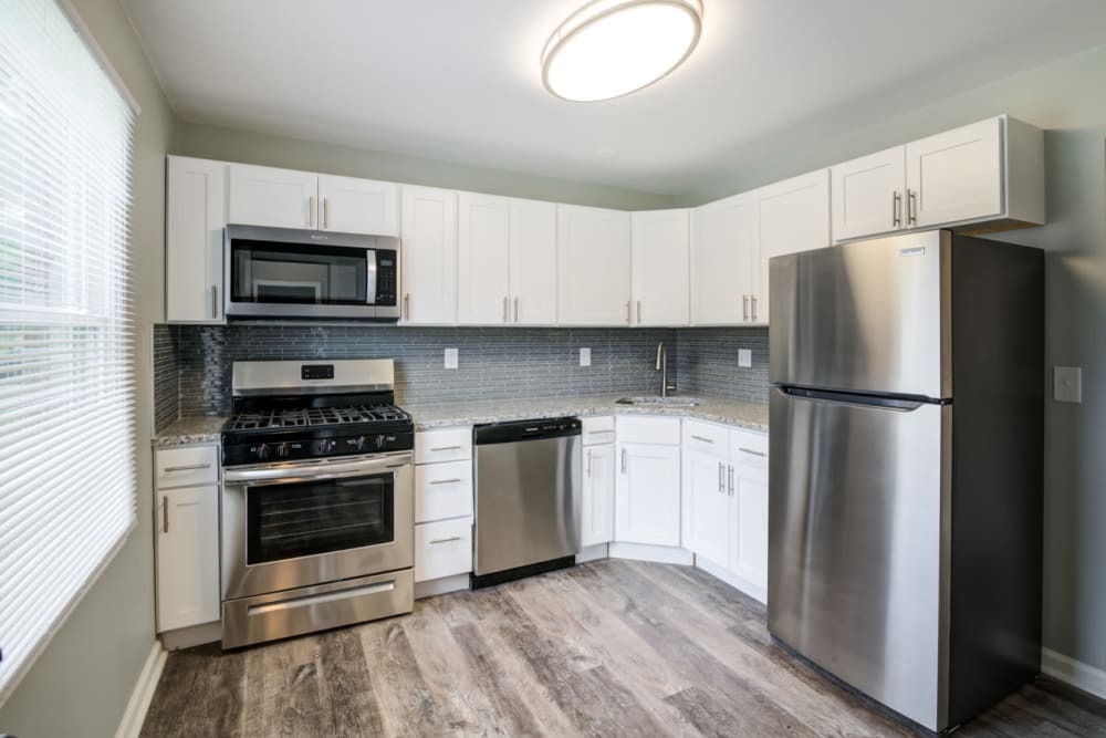 Kitchen with stainless steel appliances and granite countertops at Woodcrest Apartment Homes in Dover, Delaware