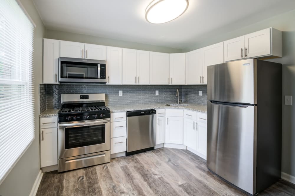 Kitchen with stainless steel appliances, and granite countertops at Woodcrest Apartment Homes in Dover, Delaware
