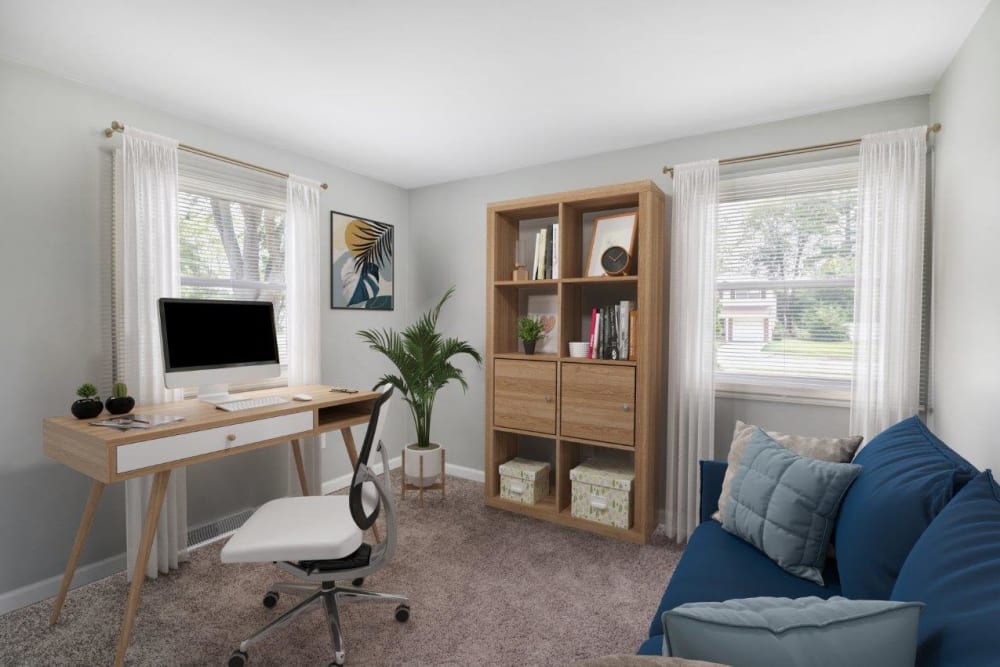 Bedroom staged with an office desk and daybed at Woodcrest Apartment Homes in Dover, Delaware