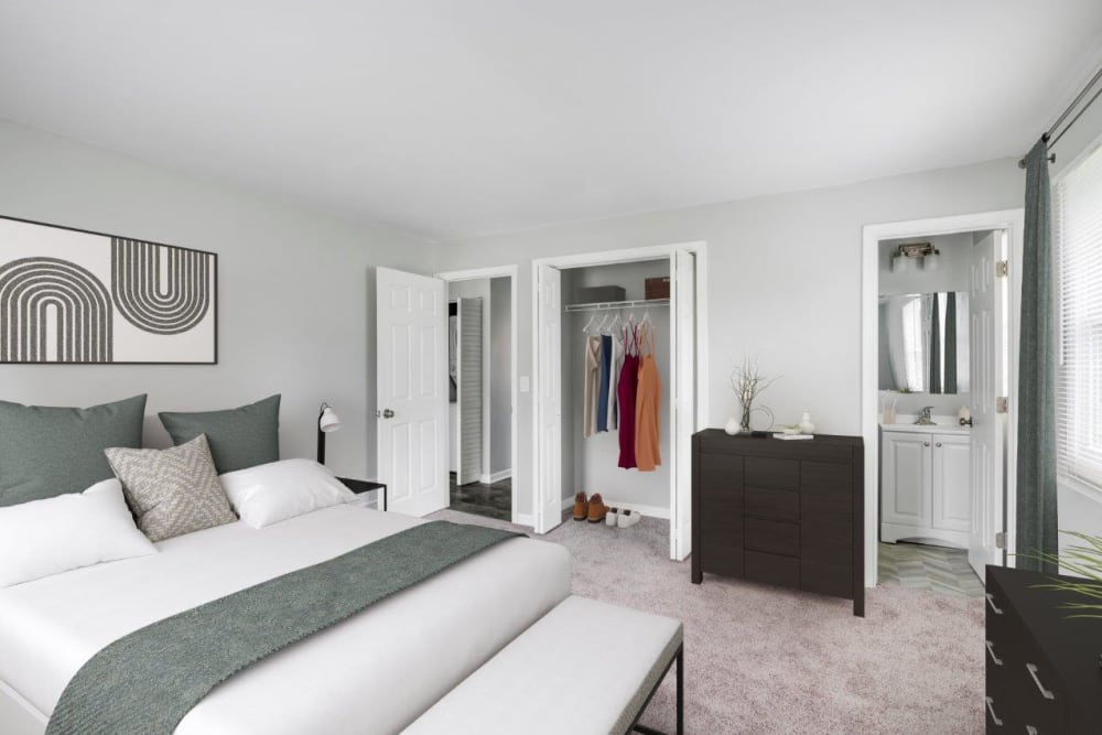 Staged bedroom with attached bath at Woodcrest Apartment Homes in Dover, Delaware