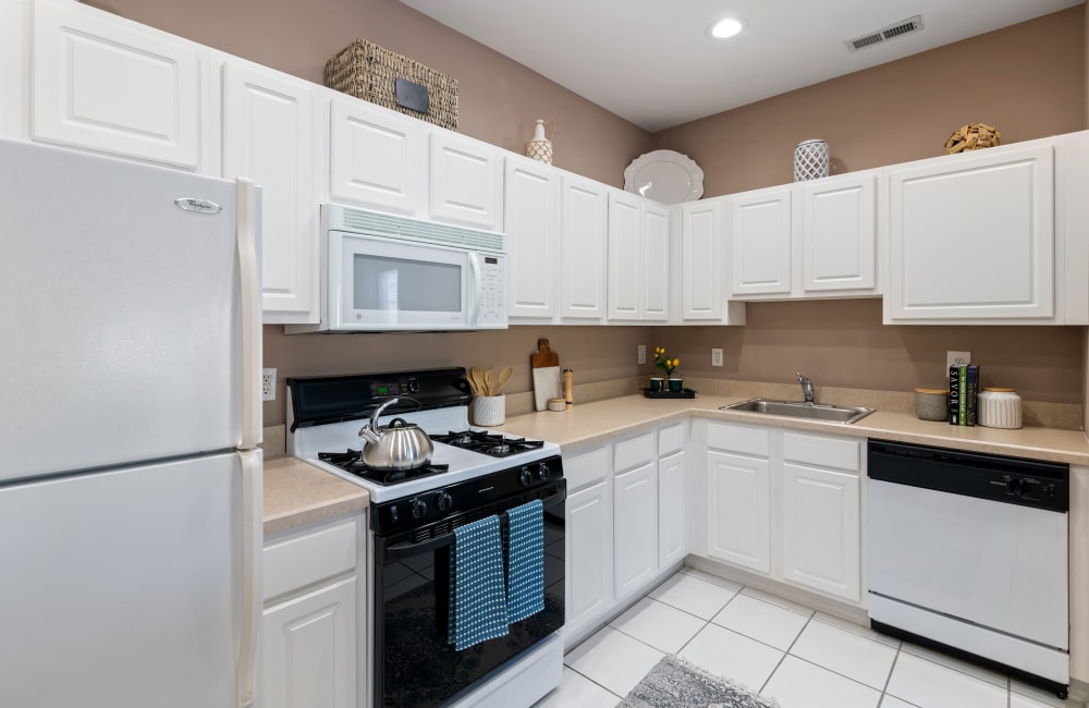 Modern kitchen with white cabinets at Woodview at Marlton Apartment Homes in Marlton, New Jersey