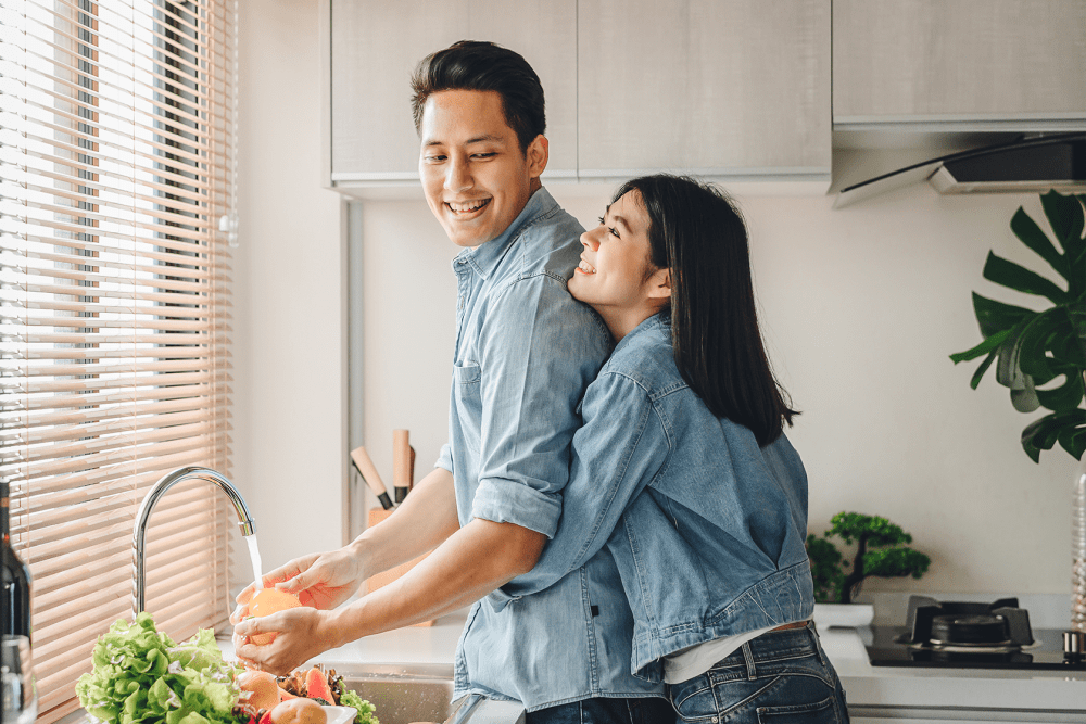 Couple cooking together in their full-equipped modern kitchen at Eagle's Crest Apartments in Harrisburg, Pennsylvania
