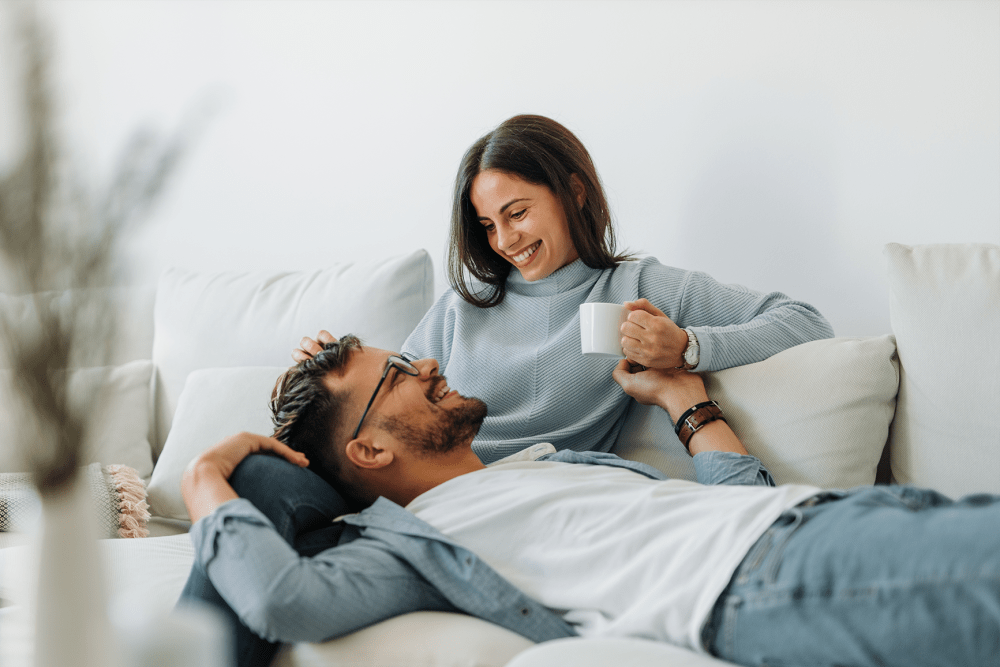 Couple relaxing in their new home at Mount Vernon Square Apartment Homes in Alexandria, Virginia