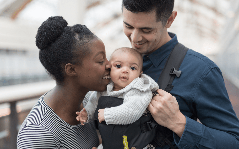 Couple out for a walk with their baby near their home at Northampton Apartment Homes in Largo, Maryland